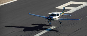 Cirrus aircraft taking off on runway. This can be done with or without air traffic control.