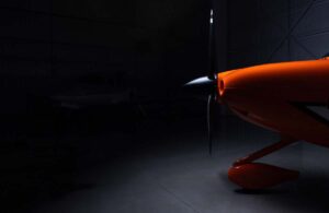 Close-up of the nose and propeller of a Cirrus SR Series G7 inside a dark hangar